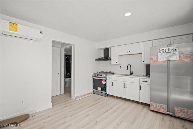 2316 Bayside St, Naples, FL 34112 - kitchen with appliances with stainless steel finishes, wall chimney range hood, an AC wall unit, a sink, and light wood-style flooring