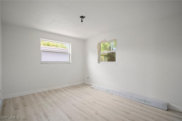 2316 Bayside St, Naples, FL 34112 - spare room with healthy amount of natural light, wood finished floors, and a baseboard radiator