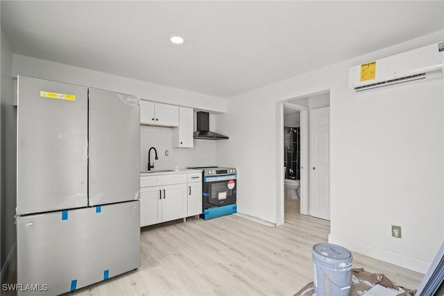 2316 Bayside St, Naples, FL 34112 - kitchen with stainless steel appliances, a sink, light wood-type flooring, a wall mounted AC, and wall chimney range hood