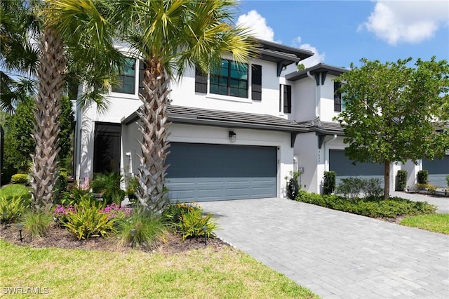 7619 Morgan Way, Naples, FL 34119 - view of front facade with stucco siding, a garage, and decorative driveway