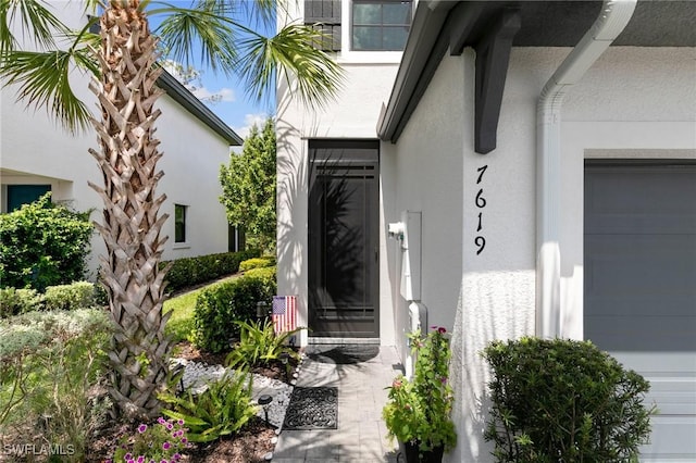 7619 Morgan Way, Naples, FL 34119 - entrance to property featuring stucco siding and a garage