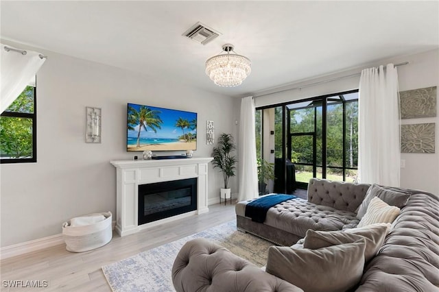 7619 Morgan Way, Naples, FL 34119 - living area with healthy amount of natural light, a chandelier, baseboards, and wood finished floors