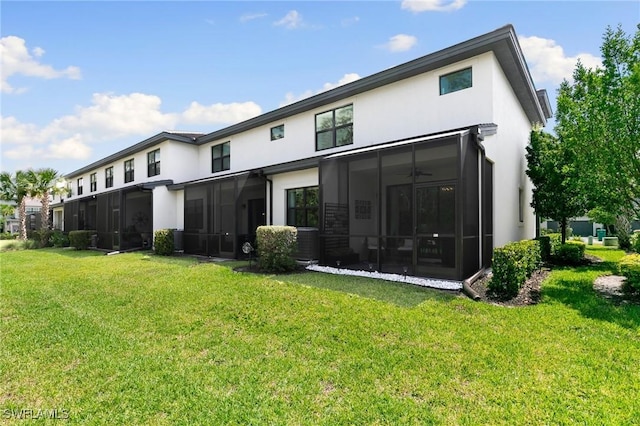 7619 Morgan Way, Naples, FL 34119 - rear view of house with stucco siding, a yard, central AC unit, and a sunroom