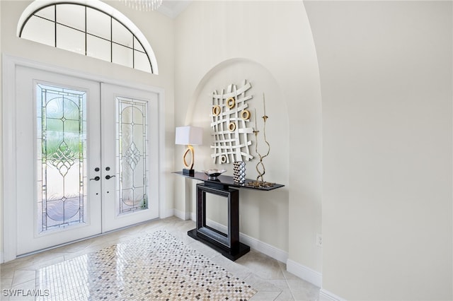 14500 Marsala Way, Naples, FL 34109 - entryway with french doors, light tile patterned flooring, and baseboards