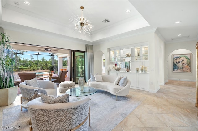 14500 Marsala Way, Naples, FL 34109 - living area with arched walkways, ornamental molding, a chandelier, a tray ceiling, and recessed lighting