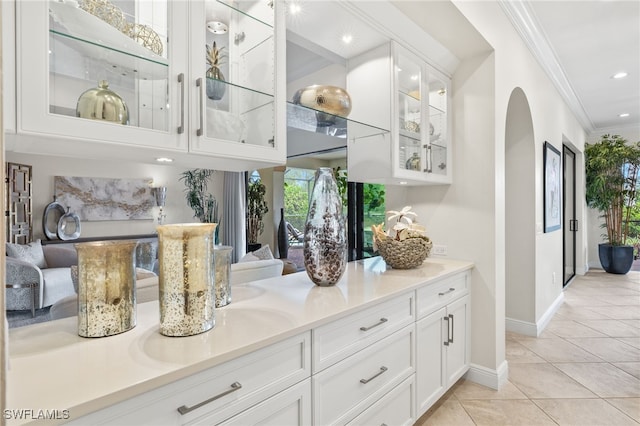 14500 Marsala Way, Naples, FL 34109 - bar with crown molding, arched walkways, light tile patterned floors, baseboards, and recessed lighting
