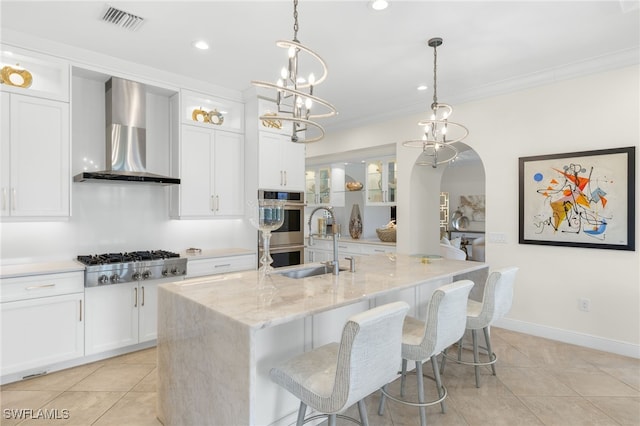 14500 Marsala Way, Naples, FL 34109 - kitchen featuring wall chimney range hood, stainless steel appliances, a sink, white cabinets, and light tile patterned floors