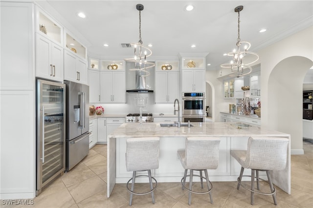14500 Marsala Way, Naples, FL 34109 - kitchen with arched walkways, a sink, stainless steel appliances, white cabinets, and recessed lighting