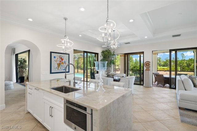 14500 Marsala Way, Naples, FL 34109 - kitchen featuring open floor plan, a sink, light tile patterned floors, crown molding, and healthy amount of natural light