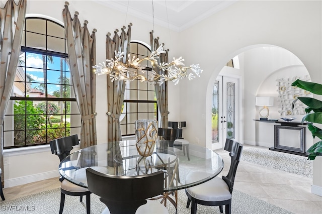 14500 Marsala Way, Naples, FL 34109 - tiled dining area with arched walkways, a chandelier, crown molding, and baseboards