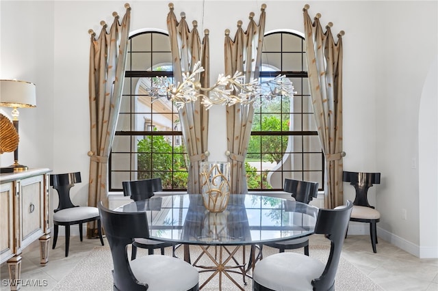 14500 Marsala Way, Naples, FL 34109 - dining area with a chandelier, light tile patterned floors, and baseboards