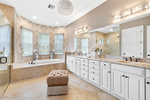 14500 Marsala Way, Naples, FL 34109 - full bath with plenty of natural light, double vanity, a shower stall, a garden tub, and recessed lighting
