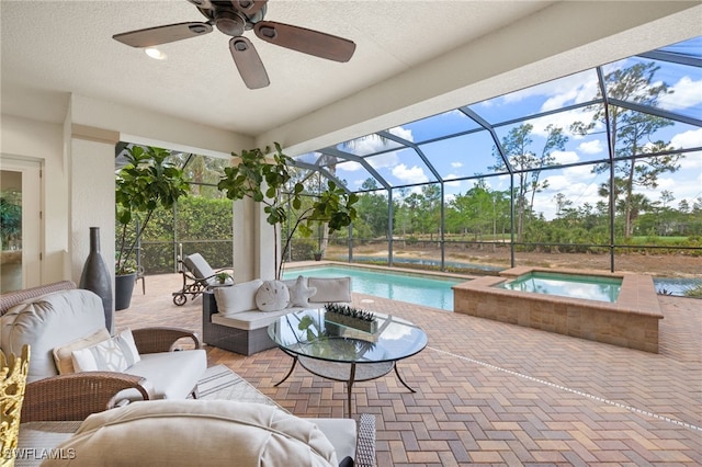 14500 Marsala Way, Naples, FL 34109 - view of patio featuring an outdoor pool, an in-ground hot tub, a ceiling fan, outdoor lounge area, and glass enclosure