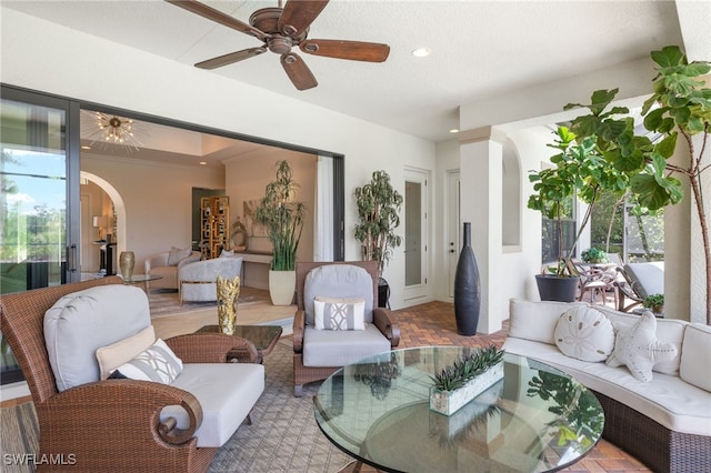 14500 Marsala Way, Naples, FL 34109 - living room featuring arched walkways, healthy amount of natural light, a ceiling fan, recessed lighting, and ornamental molding