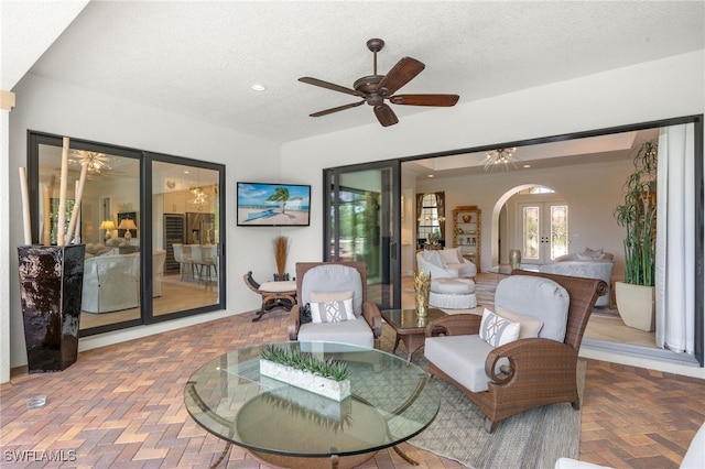 14500 Marsala Way, Naples, FL 34109 - living room with arched walkways, a textured ceiling, a ceiling fan, recessed lighting, and brick patterned floors