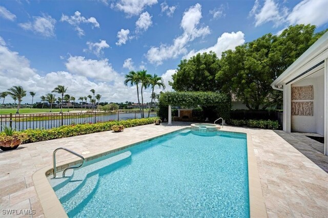 2366 Alexander Palm Dr, Naples, FL 34105 - view of swimming pool with a patio area, a pool with connected hot tub, and a water view