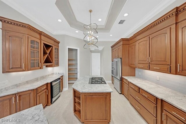 2366 Alexander Palm Dr, Naples, FL 34105 - kitchen with open shelves, a kitchen island, crown molding, stainless steel gas cooktop, and light stone counters