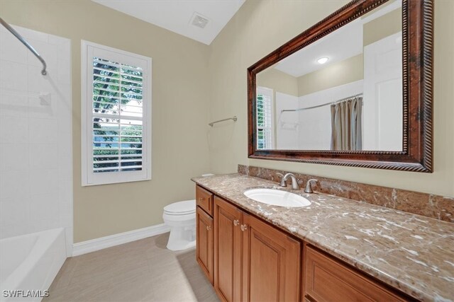 2366 Alexander Palm Dr, Naples, FL 34105 - full bathroom featuring vanity, baseboards, toilet, tile patterned flooring, and shower / bath combo