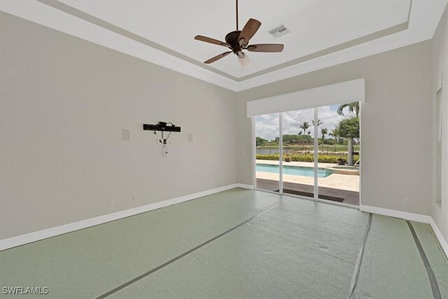 2366 Alexander Palm Dr, Naples, FL 34105 - unfurnished room with a raised ceiling, a ceiling fan, and baseboards