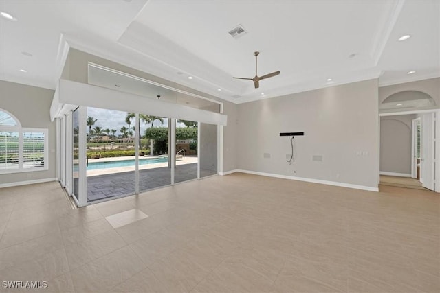 2366 Alexander Palm Dr, Naples, FL 34105 - empty room featuring a ceiling fan, arched walkways, crown molding, baseboards, and a tray ceiling