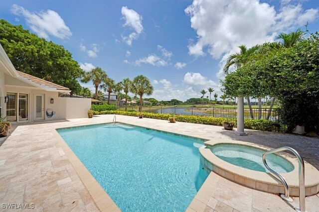 2366 Alexander Palm Dr, Naples, FL 34105 - view of swimming pool with a patio area, a pool with connected hot tub, and a water view