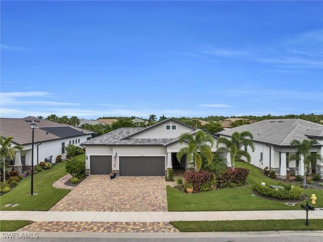 14037 Hawks Eye Ct, Estero, FL 33928 - view of front facade featuring a garage, driveway, a front lawn, and stucco siding