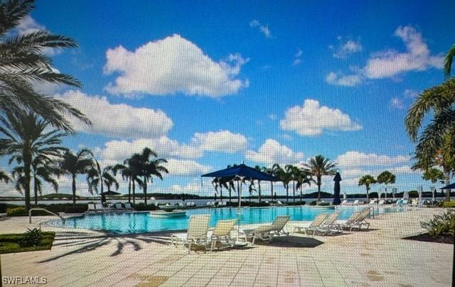 14037 Hawks Eye Ct, Estero, FL 33928 - community pool with a patio
