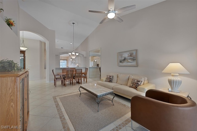 8279 Ibis Cove Cir Unit A136, Naples, FL 34119 - living area featuring high vaulted ceiling, light tile patterned floors, arched walkways, a ceiling fan, and inlaid floor details