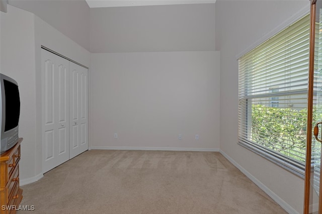 8279 Ibis Cove Cir Unit A136, Naples, FL 34119 - unfurnished bedroom with light colored carpet and a closet