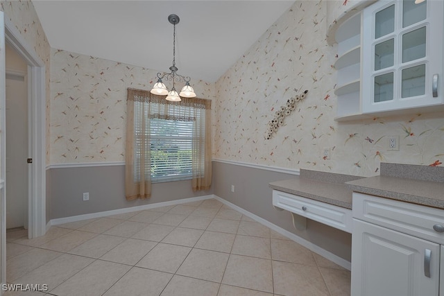 8279 Ibis Cove Cir Unit A136, Naples, FL 34119 - unfurnished dining area featuring wallpapered walls, light tile patterned flooring, and a chandelier