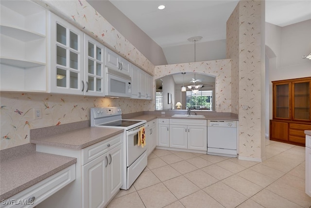 8279 Ibis Cove Cir Unit A136, Naples, FL 34119 - kitchen with white appliances, glass insert cabinets, light tile patterned floors, white cabinetry, and lofted ceiling