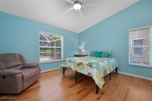8279 Ibis Cove Cir Unit A136, Naples, FL 34119 - bedroom featuring lofted ceiling, wood finished floors, and a ceiling fan