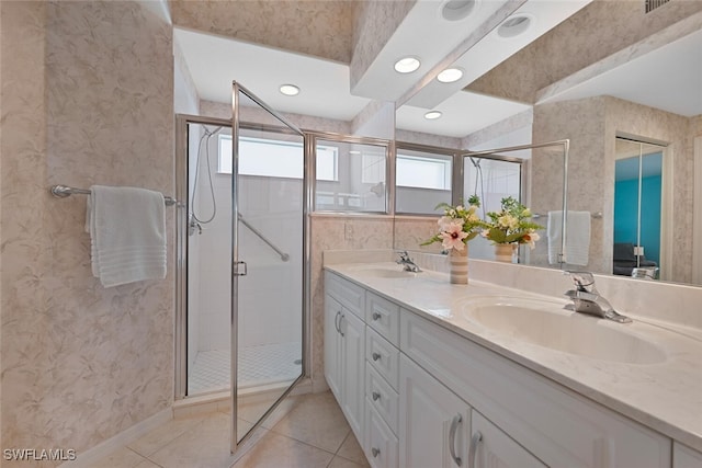 8279 Ibis Cove Cir Unit A136, Naples, FL 34119 - bathroom featuring double vanity, plenty of natural light, tile patterned flooring, a stall shower, and wallpapered walls