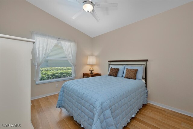 8279 Ibis Cove Cir Unit A136, Naples, FL 34119 - bedroom featuring wood finished floors, vaulted ceiling, and ceiling fan