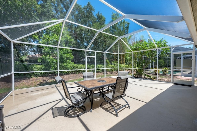8279 Ibis Cove Cir Unit A136, Naples, FL 34119 - view of patio featuring glass enclosure and outdoor dining area