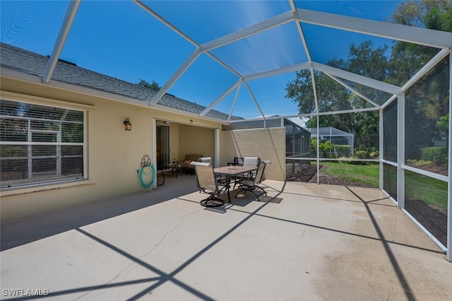 8279 Ibis Cove Cir Unit A136, Naples, FL 34119 - view of patio / terrace featuring glass enclosure and outdoor dining area
