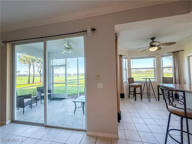 10350 Washingtonia Palm Way Unit 4213, Fort Myers, FL 33966 - doorway featuring ornamental molding, light tile patterned flooring, a ceiling fan, and baseboards