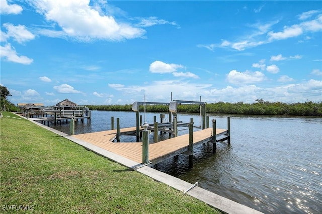 1128 NW 43rd Ave, Cape Coral, FL 33993 - dock area with boat lift, a lawn, and a water view