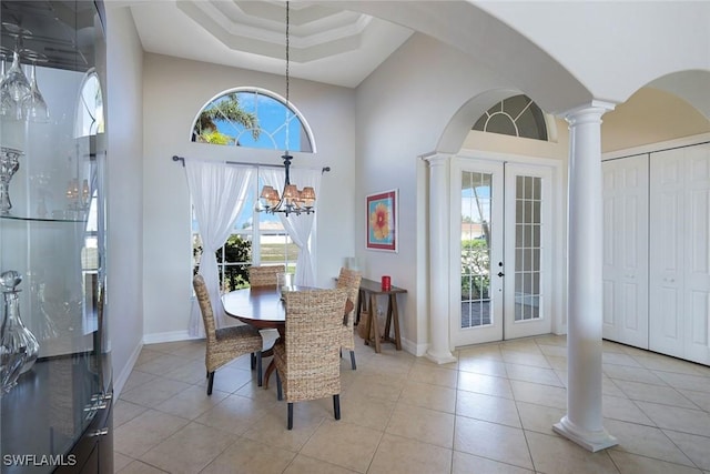 1128 NW 43rd Ave, Cape Coral, FL 33993 - dining room featuring decorative columns, plenty of natural light, french doors, light tile patterned floors, and a high ceiling