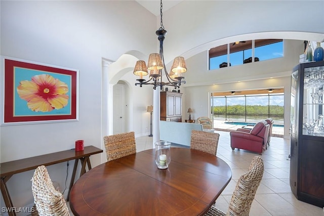 1128 NW 43rd Ave, Cape Coral, FL 33993 - dining area featuring arched walkways, high vaulted ceiling, a chandelier, and light tile patterned flooring
