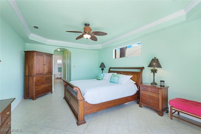 1128 NW 43rd Ave, Cape Coral, FL 33993 - bedroom with a tray ceiling, arched walkways, crown molding, light tile patterned flooring, and ceiling fan