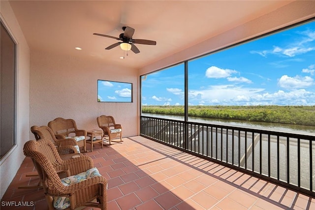 1128 NW 43rd Ave, Cape Coral, FL 33993 - sunroom / solarium with a water view, a ceiling fan, recessed lighting, tile patterned floors, and a textured wall