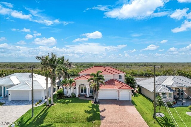 1128 NW 43rd Ave, Cape Coral, FL 33993 - view of front facade with driveway, a tiled roof, and a front yard