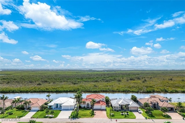 1128 NW 43rd Ave, Cape Coral, FL 33993 - aerial perspective of suburban area featuring a large body of water and a forest