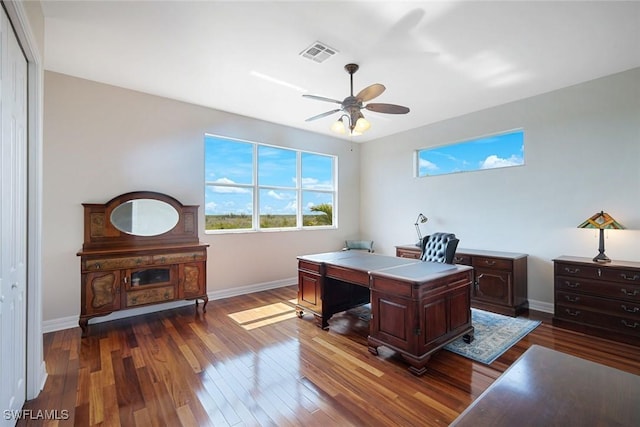 1128 NW 43rd Ave, Cape Coral, FL 33993 - home office featuring plenty of natural light, dark wood-style floors, a ceiling fan, and baseboards