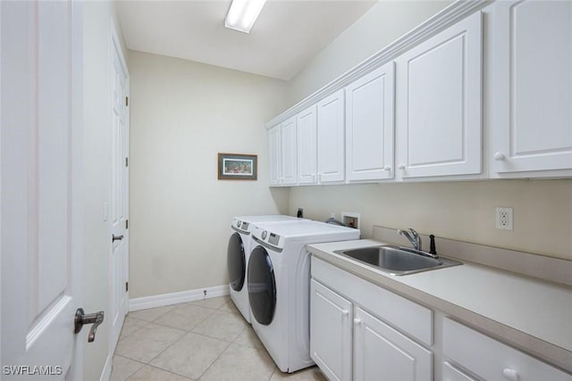 1128 NW 43rd Ave, Cape Coral, FL 33993 - laundry room with cabinet space, washing machine and clothes dryer, baseboards, and light tile patterned flooring