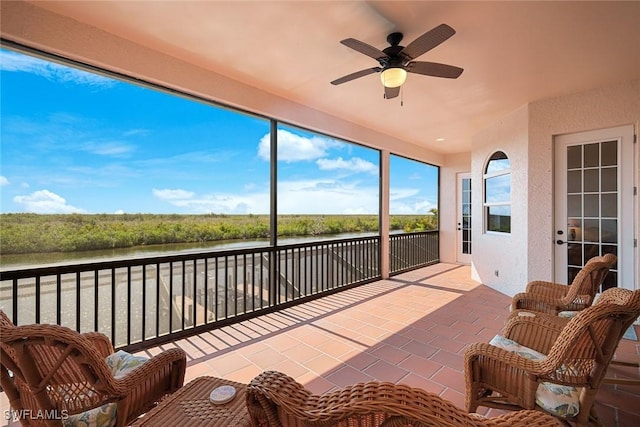 1128 NW 43rd Ave, Cape Coral, FL 33993 - sunroom with a water view, ceiling fan, and brick patterned floors