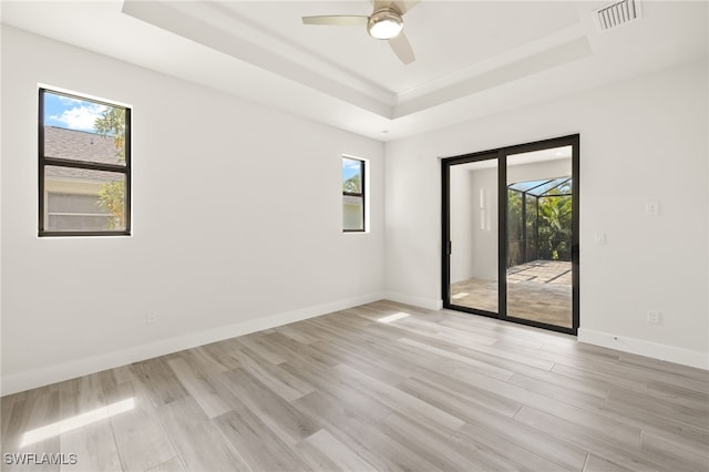 2110 SW 52nd Ter, Cape Coral, FL 33914 - empty room featuring a raised ceiling, healthy amount of natural light, and ceiling fan