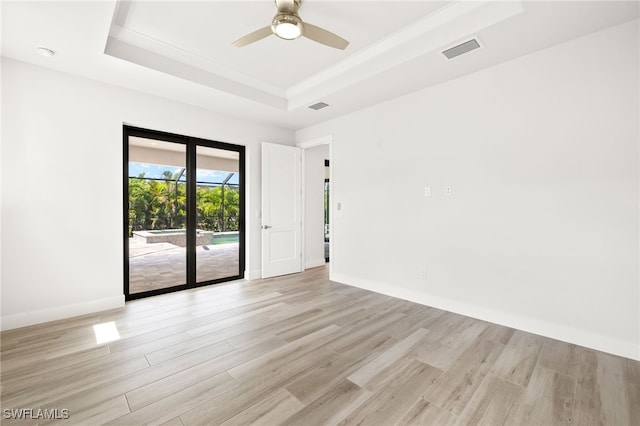 2110 SW 52nd Ter, Cape Coral, FL 33914 - unfurnished room with a tray ceiling, a ceiling fan, light wood-style flooring, and baseboards