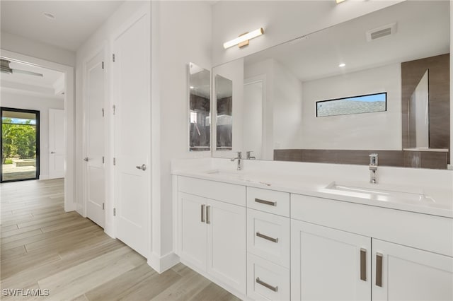 2110 SW 52nd Ter, Cape Coral, FL 33914 - bathroom with double vanity, wood finished floors, and recessed lighting